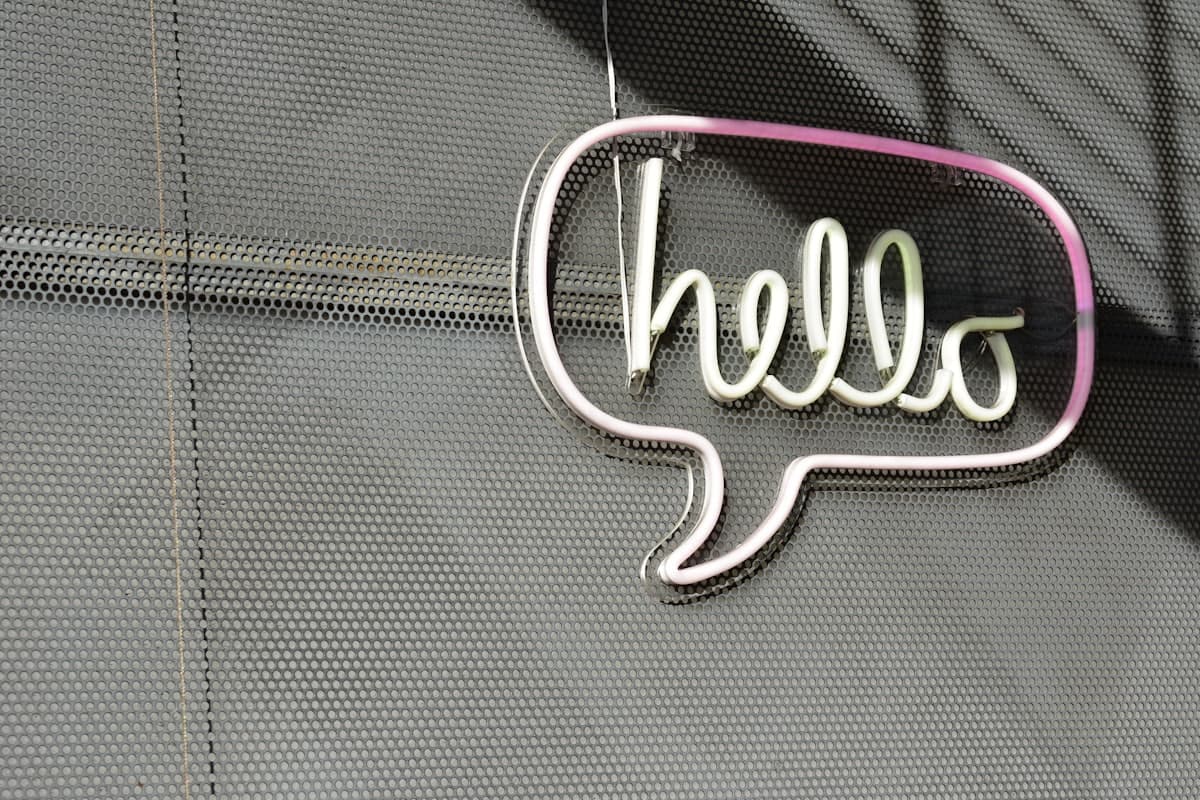 A neon sign reading hello inside a speech bubble