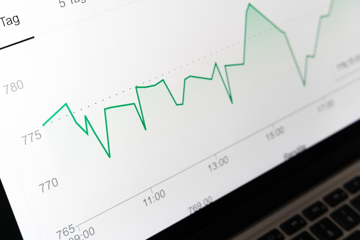 A rising performance line chart displayed on a laptop screen